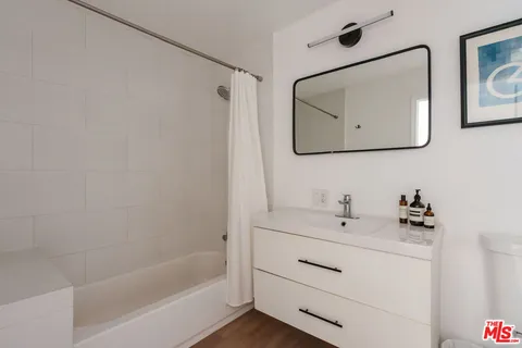 a bathroom with a sink mirror and vanity