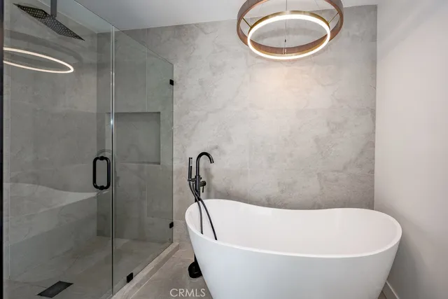a white bath tub sitting next to a shower