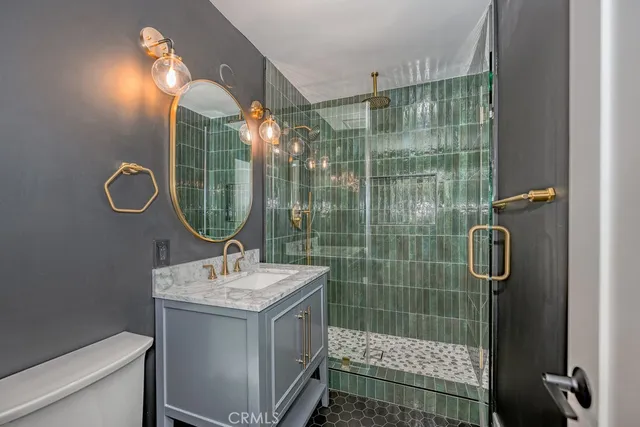a bathroom with a shower sink and mirror
