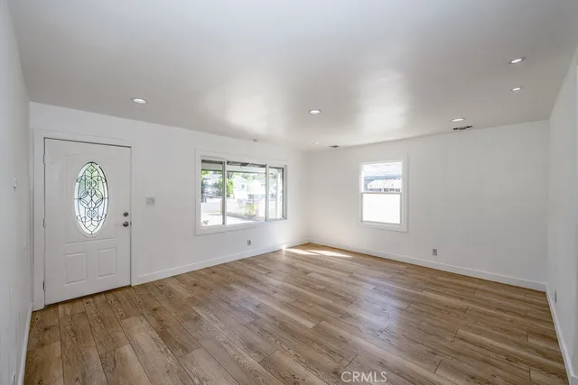 an empty room with windows and closet