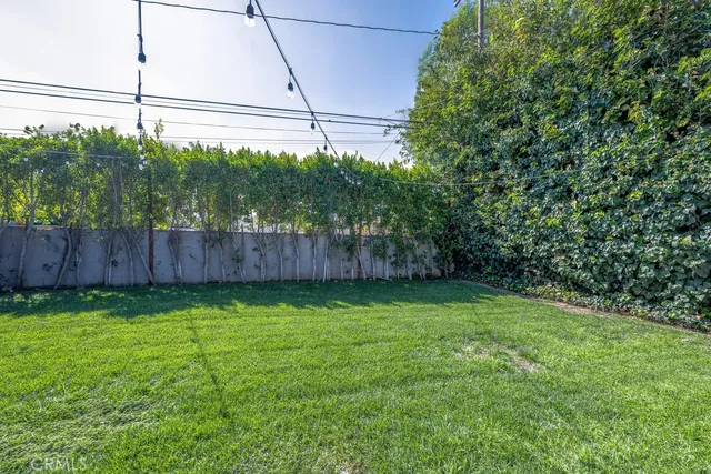 a view of a chair and table in backyard of the house