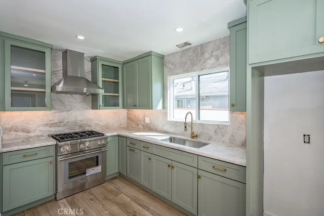 a kitchen with a sink stove and cabinets