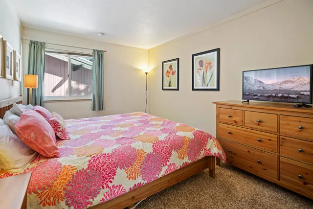 a bedroom with a bed and a dresser in it