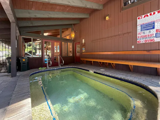 a living room with furniture a wooden floor and next to a window