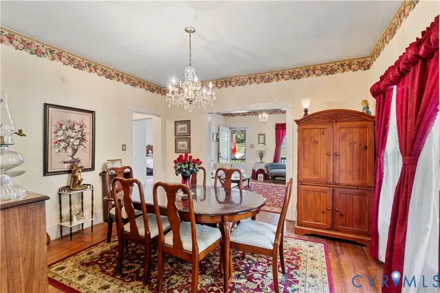 a view of a dining room with furniture and chandelier