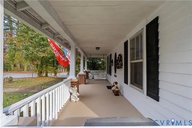a view of a patio with couches and table and chairs and floor to ceiling window