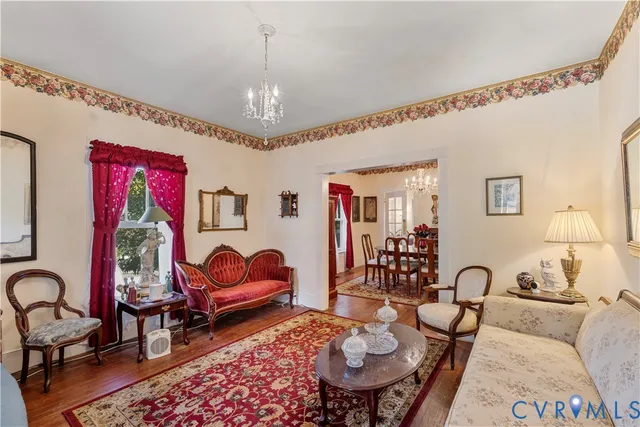 a living room with fireplace furniture and a chandelier