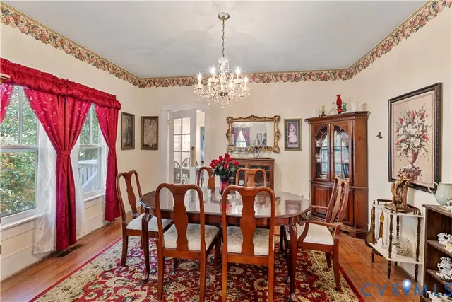 a view of a dining room with furniture and wooden floor