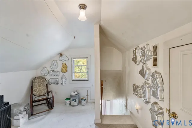 a view of a livingroom with furniture and a window