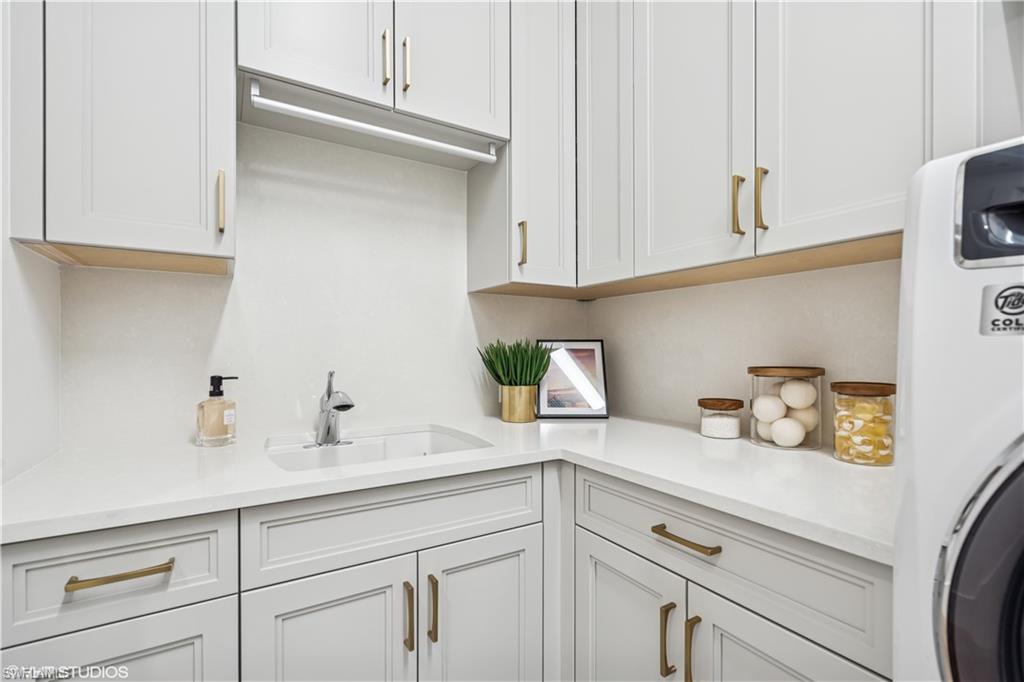 19080 Via Messina Way Miromar Lakes, FL 33913 - Photo 12 of 49 a kitchen with white cabinets and a sink