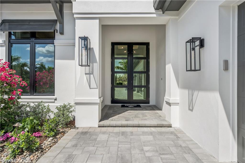 19080 Via Messina Way Miromar Lakes, FL 33913 - Photo 2 of 49 a front view of a house with a porch