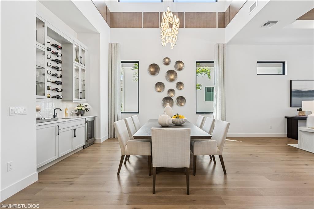 19080 Via Messina Way Miromar Lakes, FL 33913 - Photo 22 of 49 a view of a dining room with furniture and wooden floor