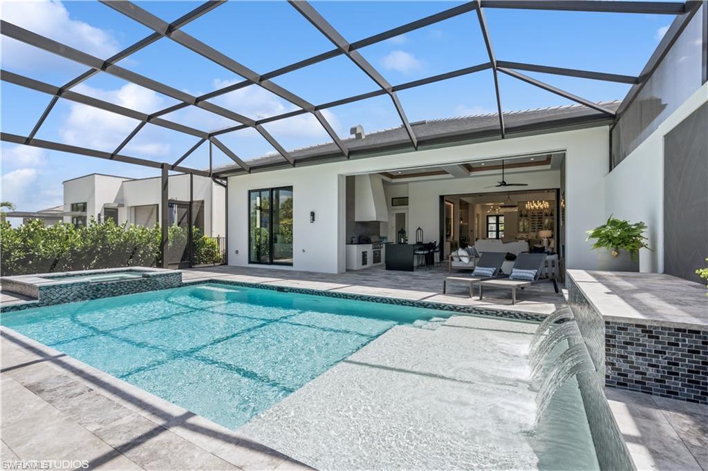 19080 Via Messina Way Miromar Lakes, FL 33913 - Photo 3 of 49 a view of a patio with table and chairs under an umbrella