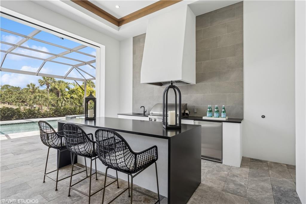 19080 Via Messina Way Miromar Lakes, FL 33913 - Photo 34 of 49 a kitchen with a table and chairs in it