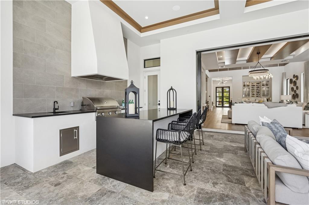 19080 Via Messina Way Miromar Lakes, FL 33913 - Photo 36 of 49 a kitchen with stainless steel appliances kitchen island granite countertop a sink and cabinets