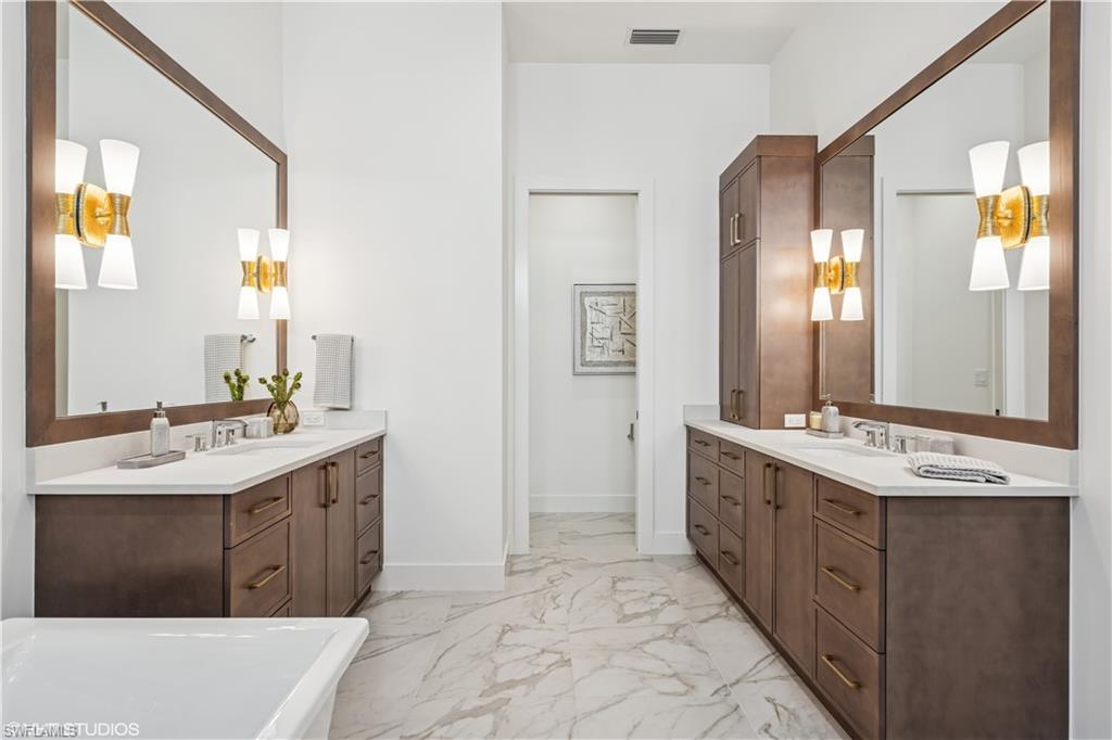 19080 Via Messina Way Miromar Lakes, FL 33913 - Photo 41 of 49 a spacious bathroom with a double vanity sink mirror and