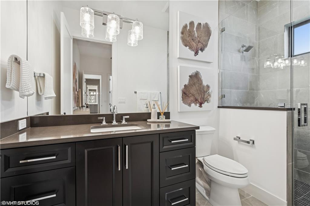 19080 Via Messina Way Miromar Lakes, FL 33913 - Photo 10 of 49 a bathroom with a granite countertop toilet sink and mirror