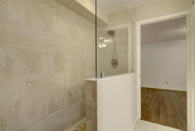 a view of a kitchen with stainless steel appliances granite countertop cabinets and a refrigerator