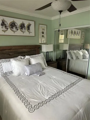 a bedroom with a bed and ceiling fan