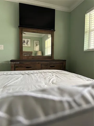 a bedroom with a bed and a tv