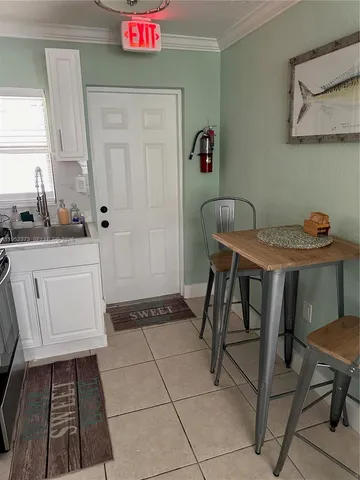a hallway with a table and chairs
