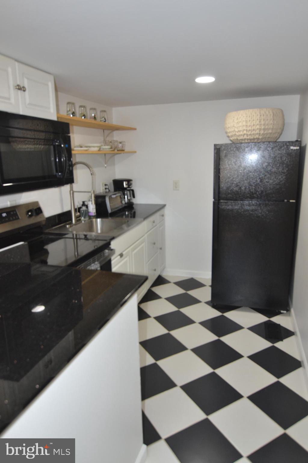 1410 West Locust Street York, PA 17404 - Photo 12 of 23 a kitchen with a sink a refrigerator and cabinets