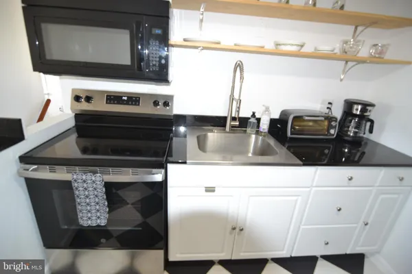 a kitchen with a stove and a microwave