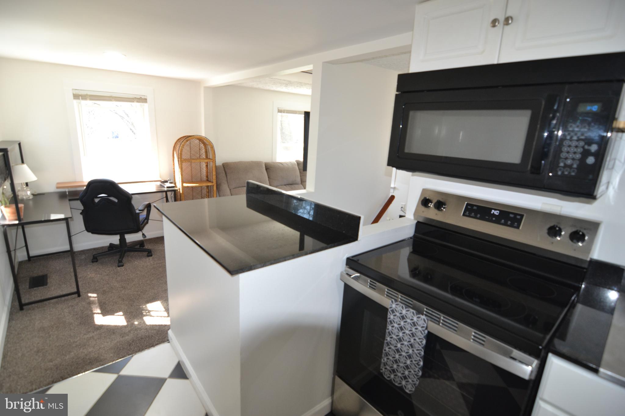 1410 West Locust Street York, PA 17404 - Photo 14 of 23 a kitchen with a stove and a microwave