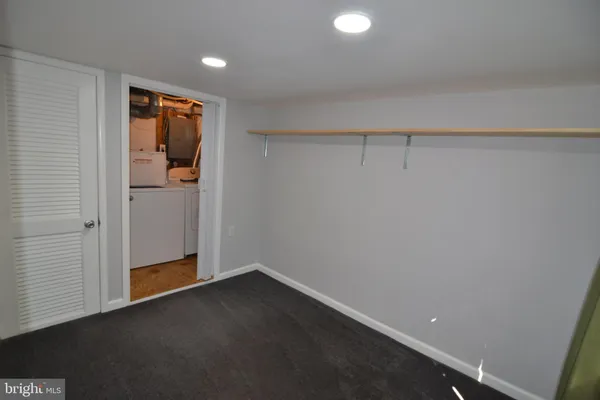 a view of an empty room with closet