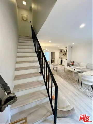 a spacious bedroom with a bed and a dresser next to a window