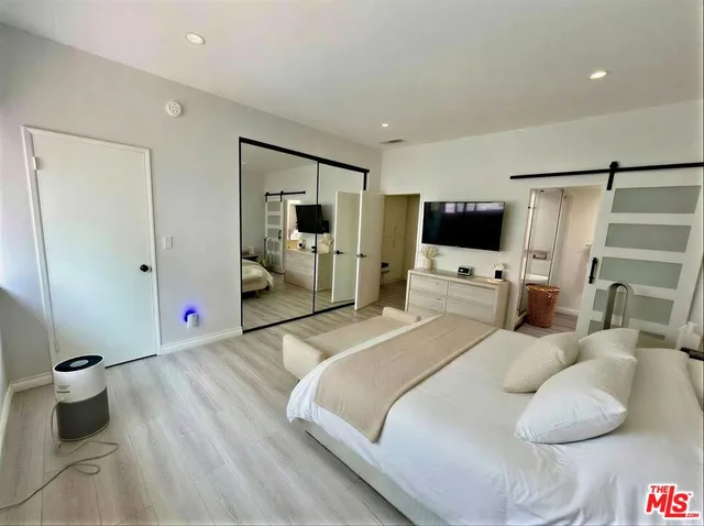 a bedroom with a bed and a mirror