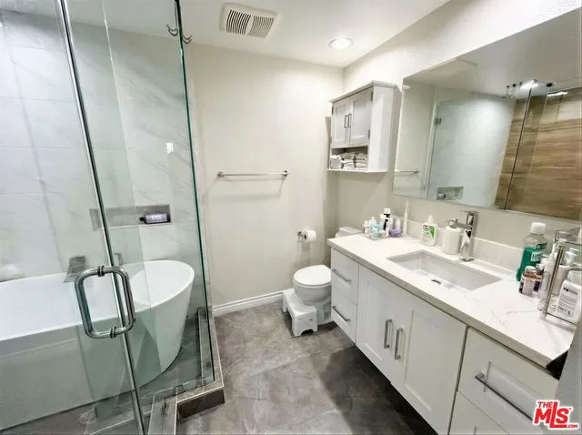 a bathroom with a shower and a sink