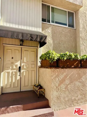 a view of a house with backyard porch and sitting area