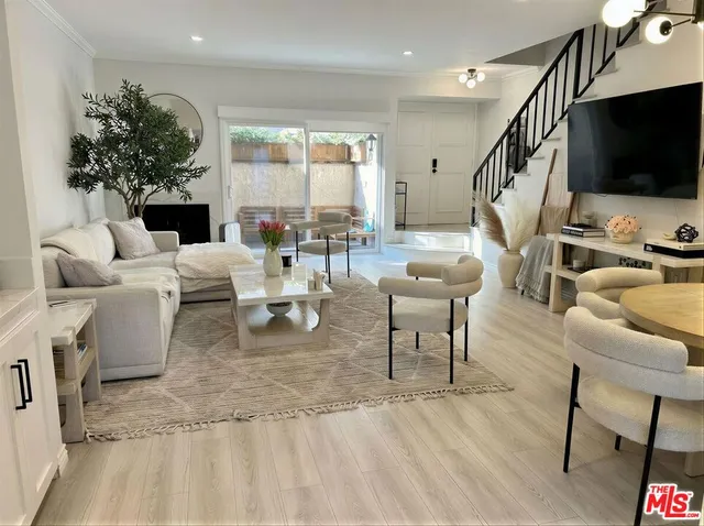 a living room with fireplace furniture and a flat screen tv