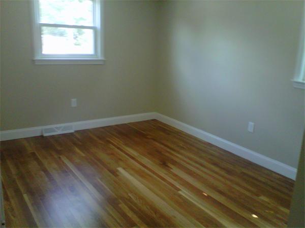 241 Salem Road Billerica, MA 01821 - Photo 8 of 24 an empty room with wooden floor and windows