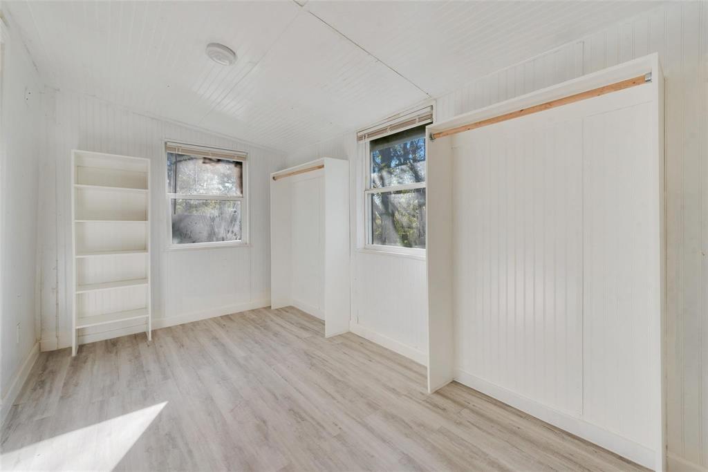109 Lydia Street Terrell, TX 75160 - Photo 4 of 22 an empty room with wooden floor and windows
