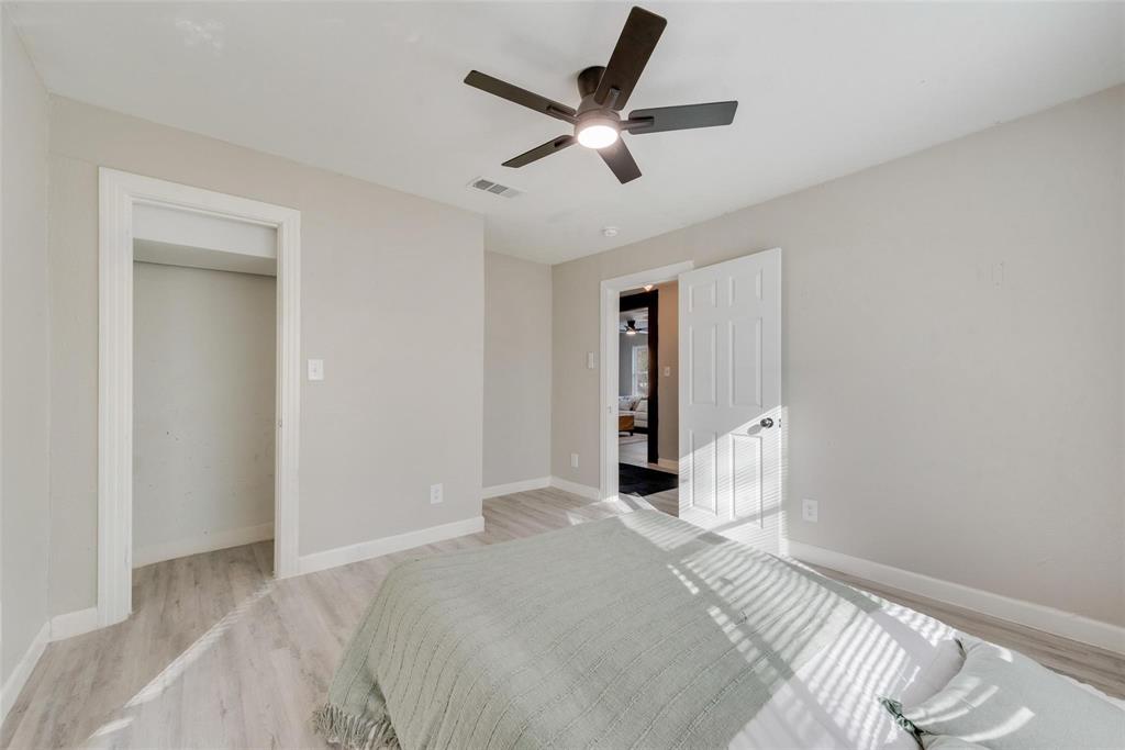 109 Lydia Street Terrell, TX 75160 - Photo 6 of 22 a bedroom with a large bed and a chandelier