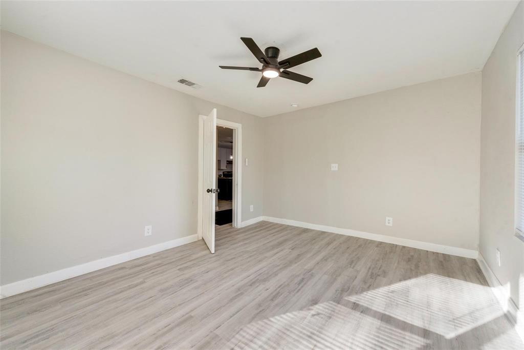 109 Lydia Street Terrell, TX 75160 - Photo 9 of 22 an empty room with wooden floor and windows