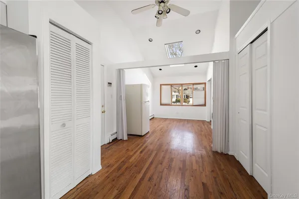 a view of hallway with wooden floor and window