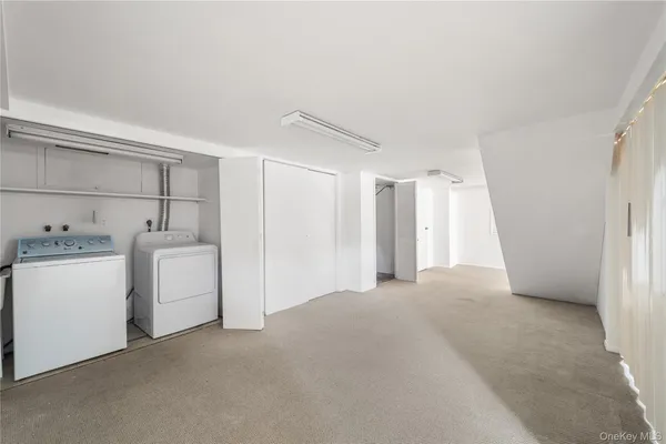 a view of empty room with closet and cabinet
