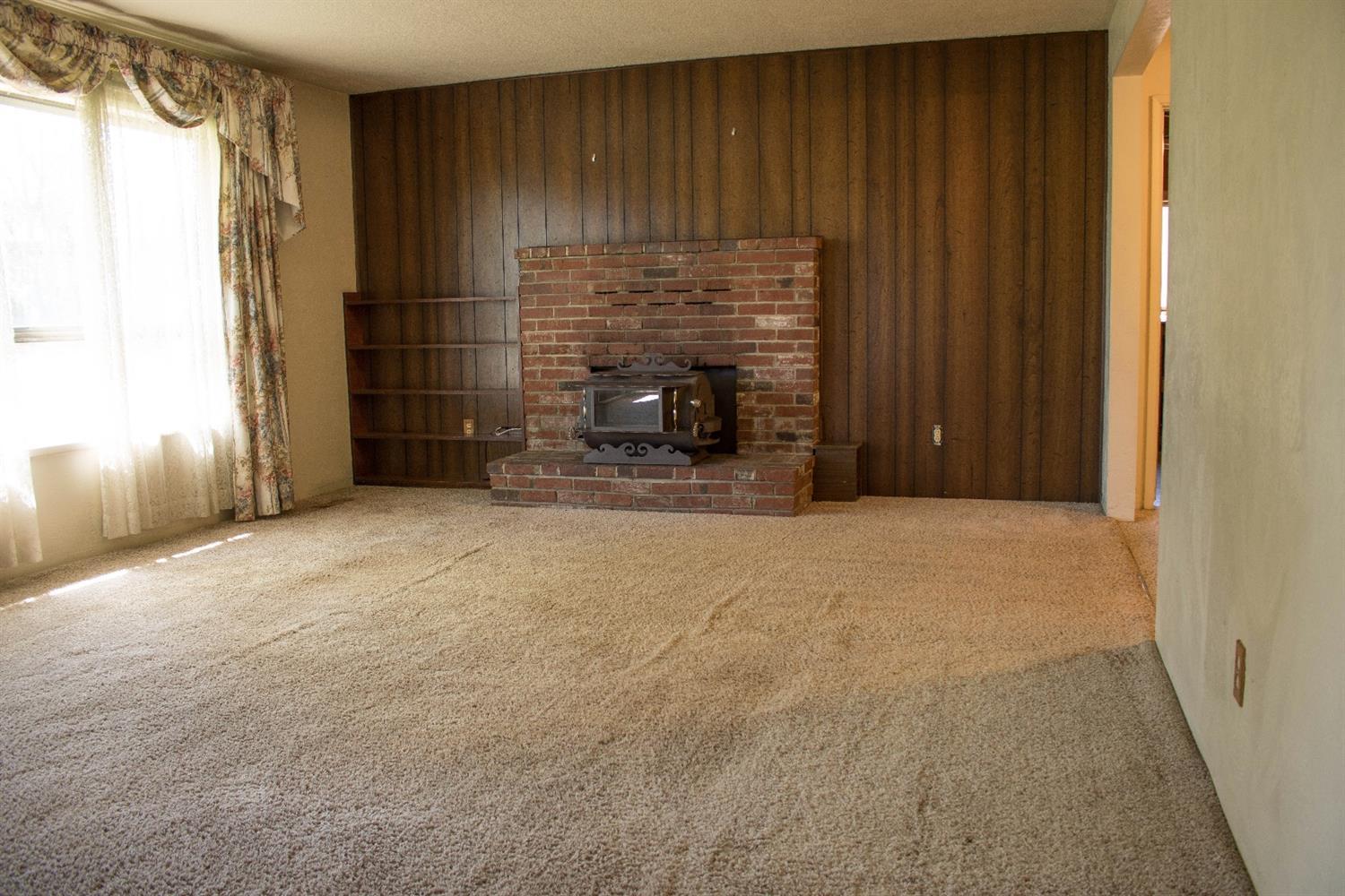 2613 Table Rock Road Medford, OR 97501 - Photo 2 of 23 a view of an empty room with a fireplace and a window