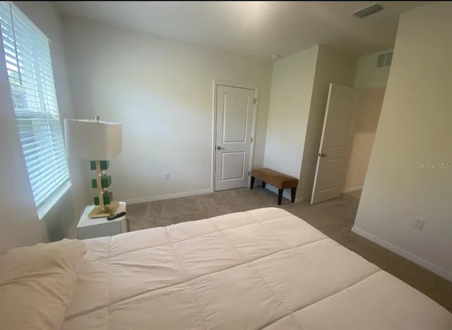 a bedroom with a bed and a window