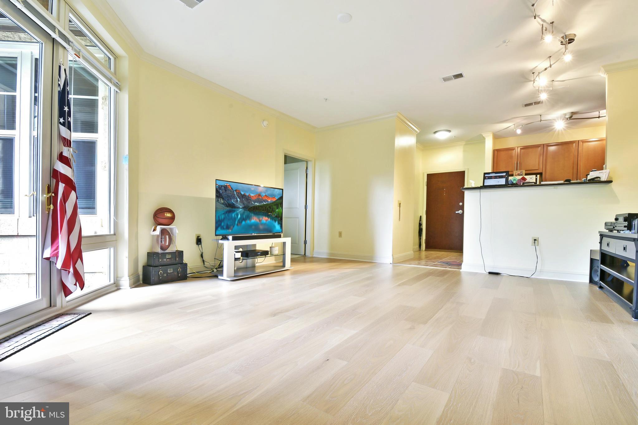 11770 Sunrise Valley Drive, Unit 120 Reston, VA 20191 - Photo 16 of 41 a view of a livingroom with furniture and a flat screen tv