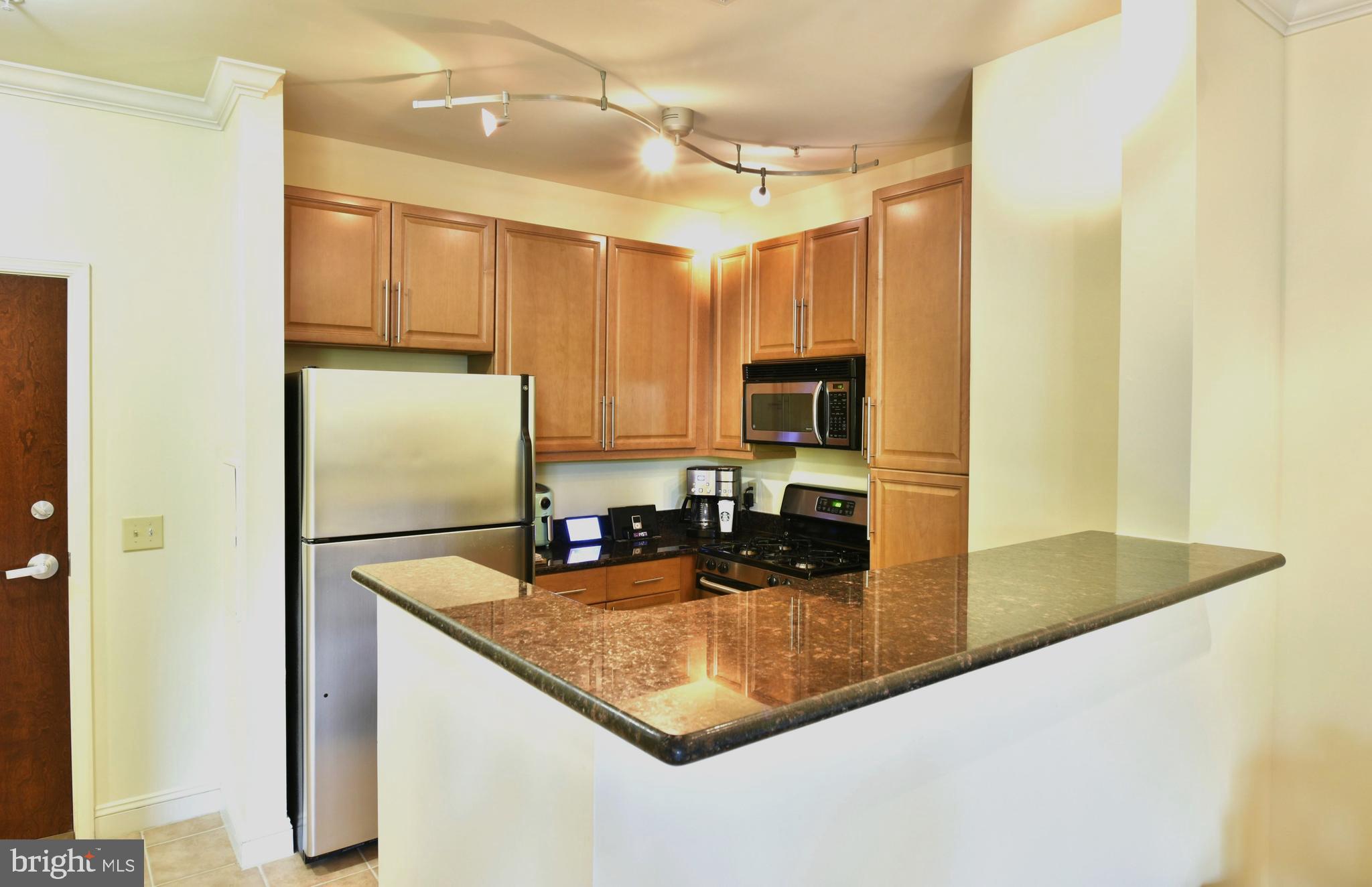 11770 Sunrise Valley Drive, Unit 120 Reston, VA 20191 - Photo 19 of 41 a kitchen with sink refrigerator and microwave