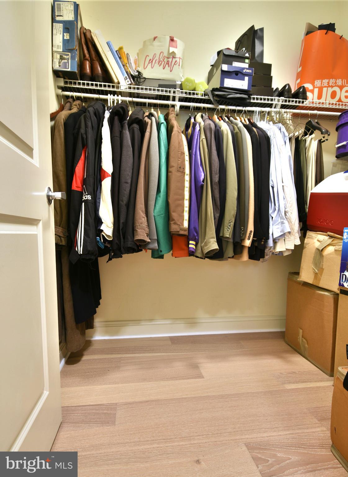 11770 Sunrise Valley Drive, Unit 120 Reston, VA 20191 - Photo 29 of 41 a view of walk in closet with clothes and shoes