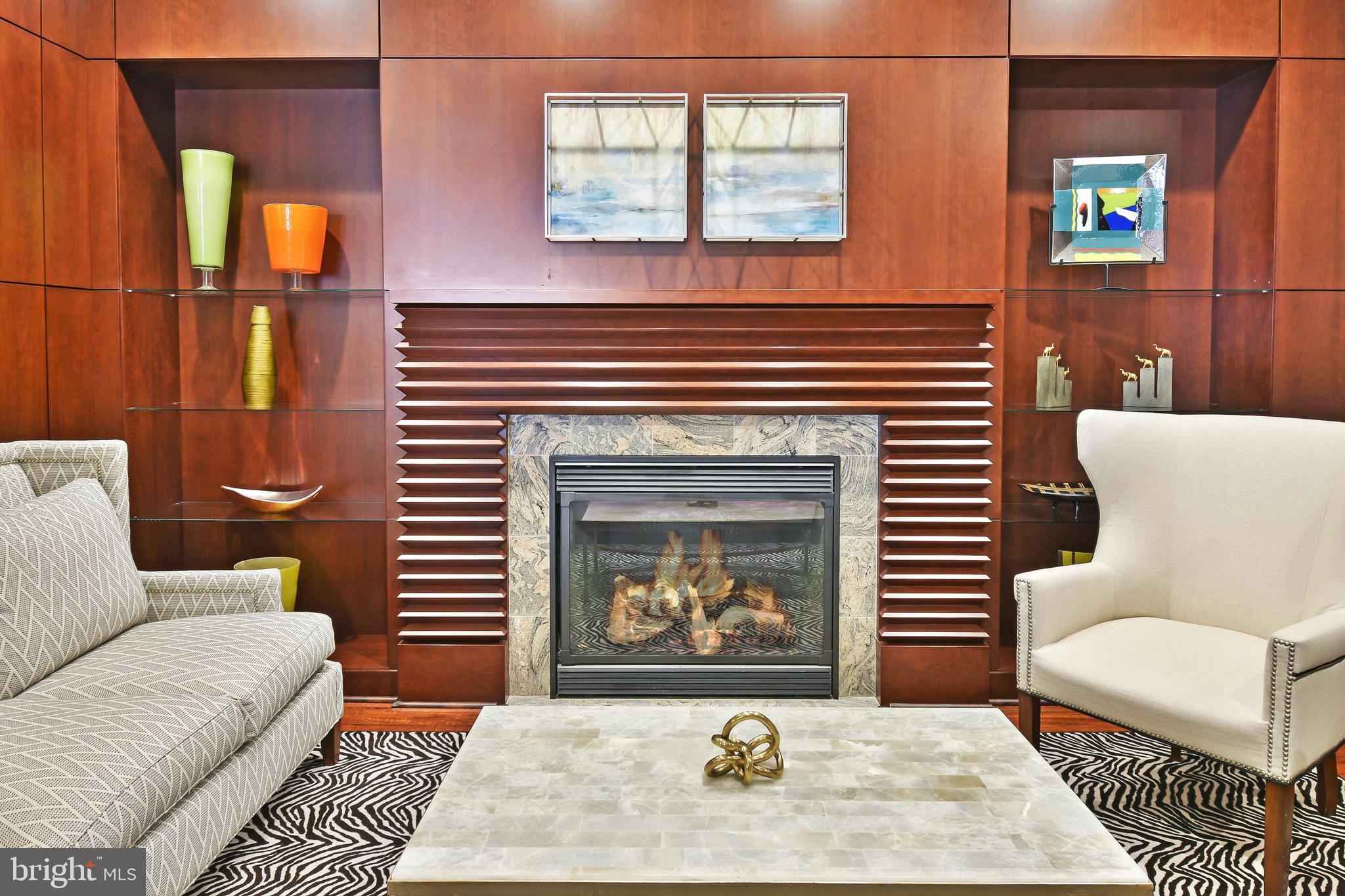 11770 Sunrise Valley Drive, Unit 120 Reston, VA 20191 - Photo 40 of 41 a living room with furniture a rug and a fireplace