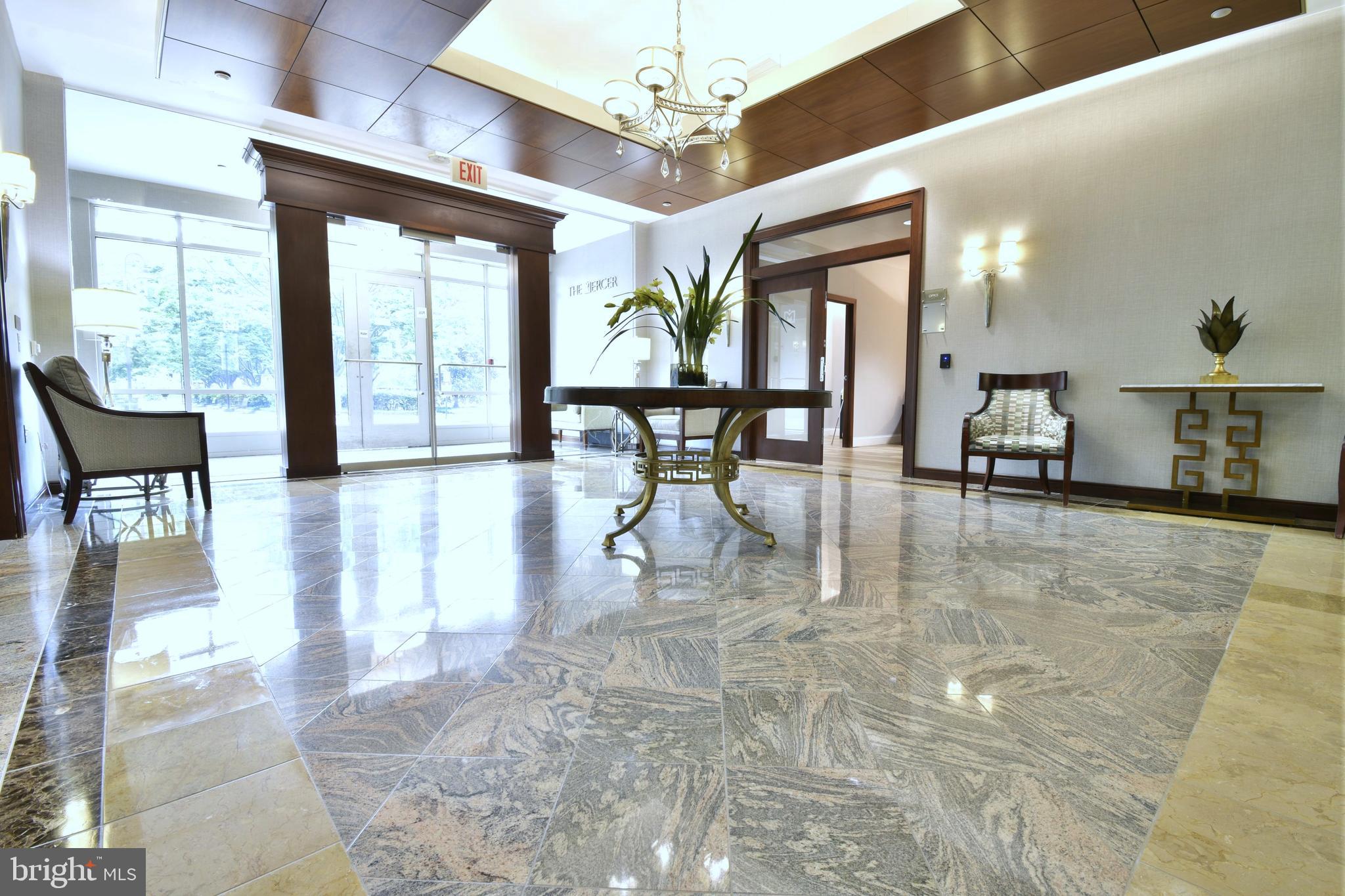 11770 Sunrise Valley Drive, Unit 120 Reston, VA 20191 - Photo 4 of 41 a view of a dining room with furniture a chandelier and large windows