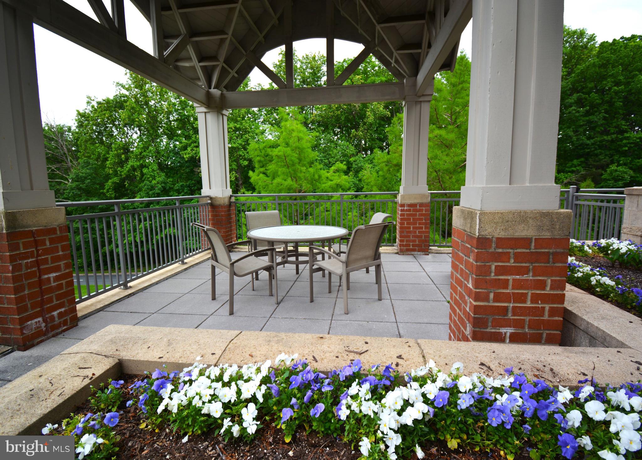 11770 Sunrise Valley Drive, Unit 120 Reston, VA 20191 - Photo 7 of 41 a view of a patio with a table and chairs