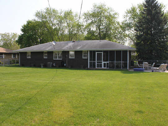 7175 Ralph Road Rockford, IL 61109 - Photo 2 of 11 a view of a house with a yard and sitting area