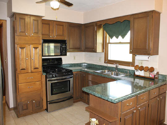 7175 Ralph Road Rockford, IL 61109 - Photo 3 of 11 a kitchen with granite countertop a stove sink and cabinets